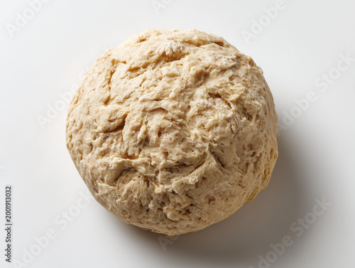 Bread dough ball resting on white background