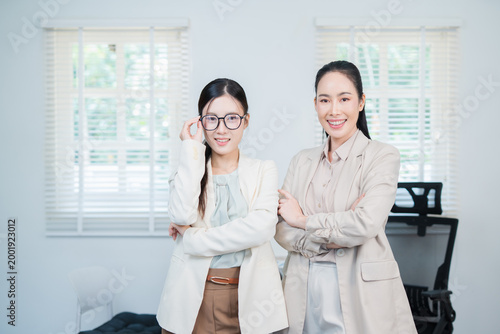 A successful Asian businesswoman, looking confident and smiling.