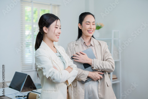 A successful Asian businesswoman, looking confident and smiling.
