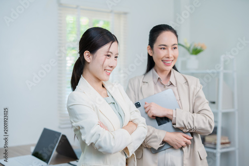 A successful Asian businesswoman, looking confident and smiling.