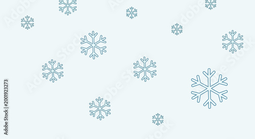Snowflakes fall gently in cold weather under cloudy skies in winter landscape.