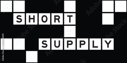 Alphabet letter in word short supply on crossword puzzle background