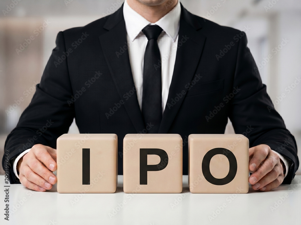 Obraz premium premium banker behind ipo blocks representing stock market launch equity investment and public offering concept