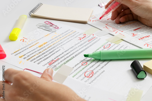 Slika na platnu Close-up of proofreading process with red, green pens corrections and highlighte
