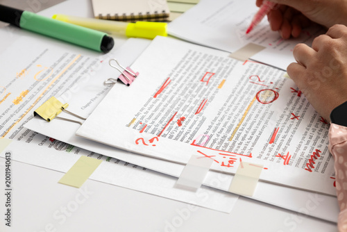 Canvas Print Student or editor analyzing written assignment with notes and highlights, checki