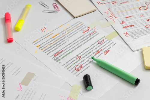 Improving writing skills through editing and revision, marking errors and refining text for better readability and structure
