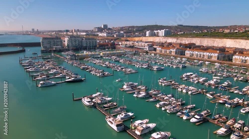 Ascending drone shot over Brighton Marina showing coastal city skyline