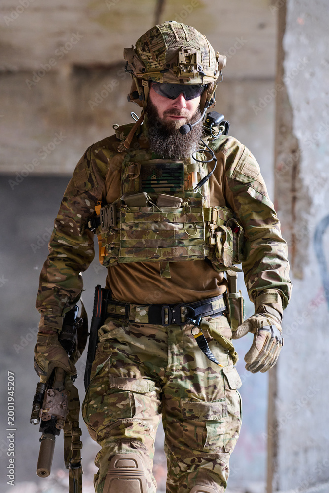 Fototapeta premium Tactical Soldier in Multicam Gear With Helmet, Chest Rig and Rifle in Urban Environment