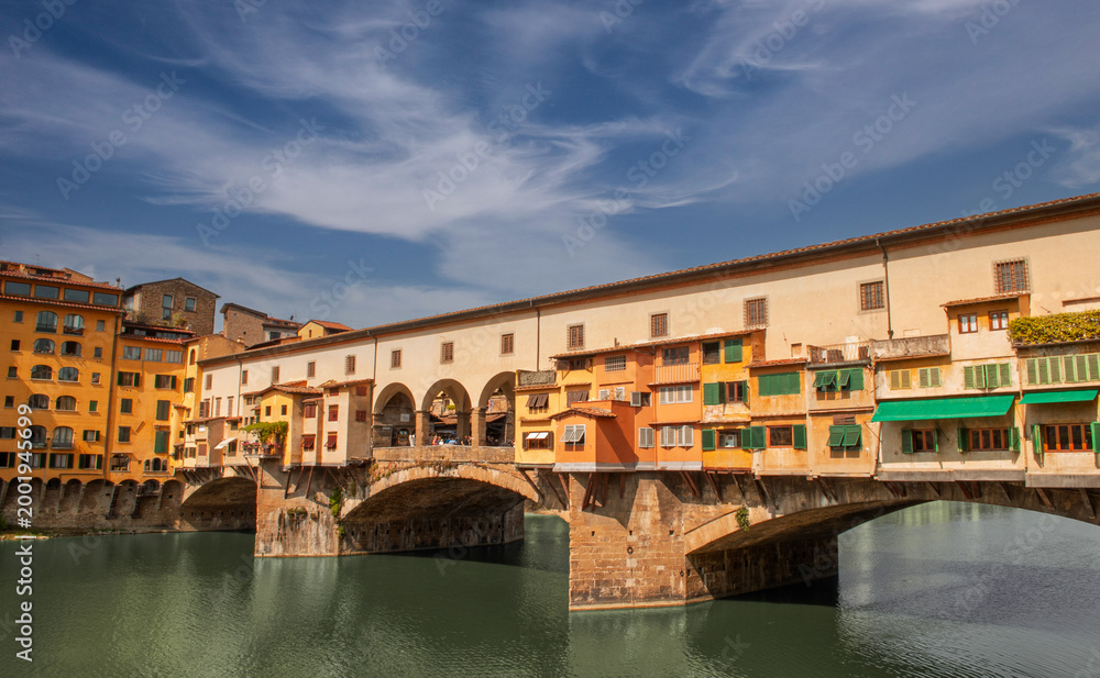 Naklejka premium Ponte Vecchio in Florence, originally built in 1345, is famous for the characteristic shops built above the structure
