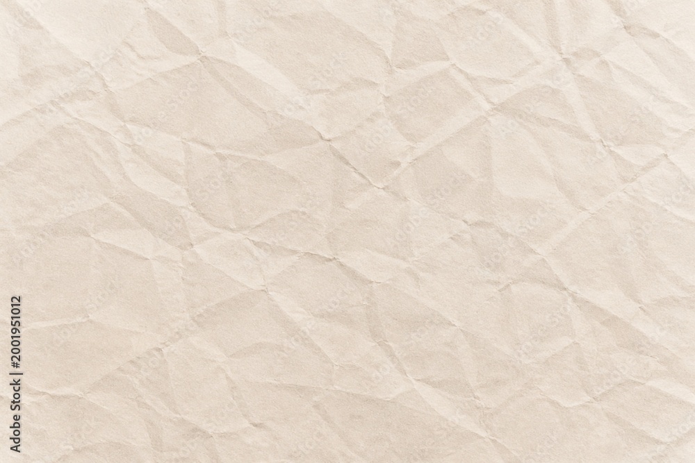 Fototapeta premium Soft beige crumpled paper texture background with realistic folds
