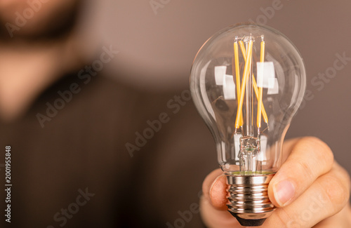 Person holding a light bulb...