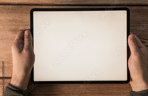 Close up of hands holding a...