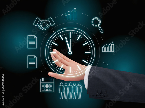 A hand in a business suit presenting a glowing clock surrounded by productivity and management icons on a dark background