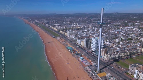 Modern observation tower i360 rising above Brighton beach and coastline