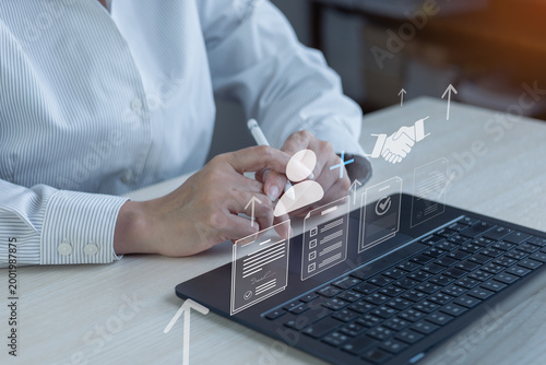 Obraz na płótnie Business user managing supplier onboarding and procurement approval on laptop with digital document workflow and partnership icons