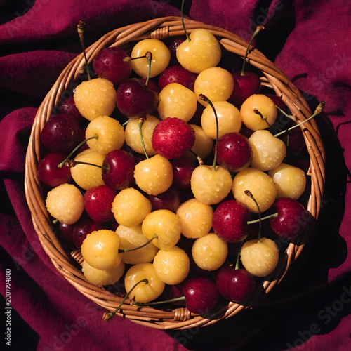 top view of basket full of yellow and red cherries