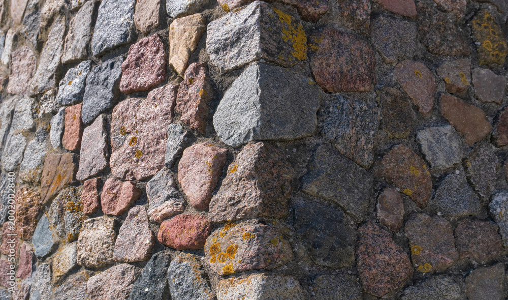 Fototapeta premium Close-up of an ancient stone wall corner texture