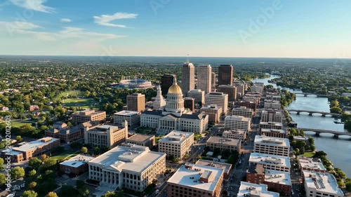 An aerial view showcases the vibrant cityscape of Oklahoma City, Oklahoma, highlighting its iconic capitol building and sprawling urban landscape alongside the Arkansas River.