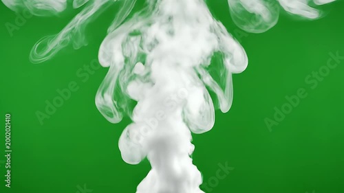 A swirling cloud of white ink blooms against a vibrant green screen background.