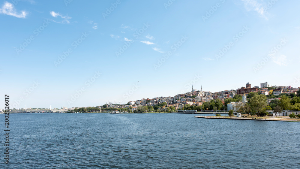 Fototapeta premium A city view from the Golden Horn in Istanbul, showing mosques and churches.