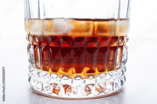 Whiskey with Ice in Crystal Glass Close Up on White Background