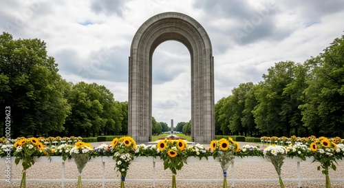 Triumphant arch monument with floral tributes in a park