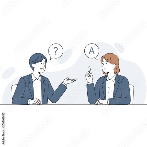 Two businesswomen discuss and explain information in a meeting