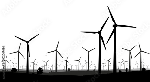 silhouette of wind turbines in a field at sunset