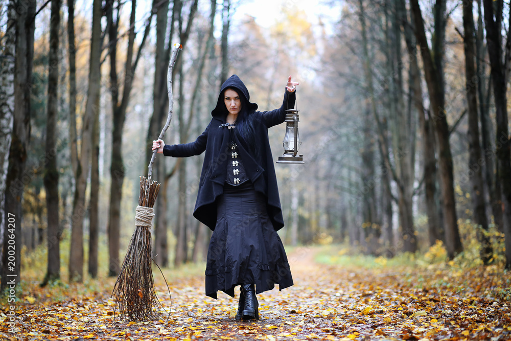 Fototapeta premium A woman in a witch suit in a forest