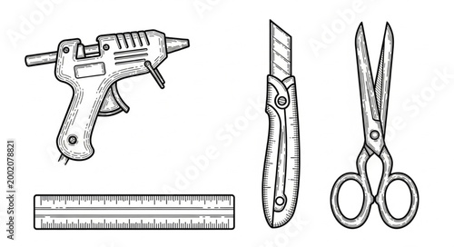 Crafting tools including hot glue gun cutter ruler and scissors.