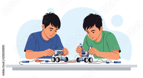 Two young boys working together to assemble and program small robots on a table as part of a science and technology education project.
