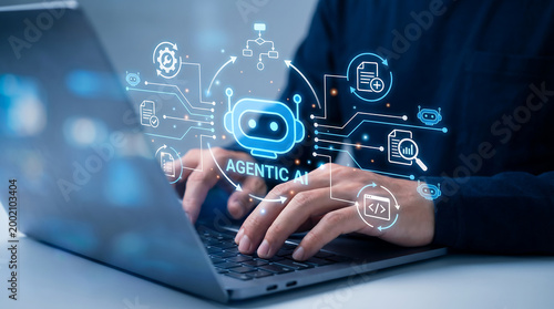 Programmer working on laptop with glowing agentic AI interface featuring robotic icons and code flow symbols representing advanced autonomous artificial intelligence and software automation