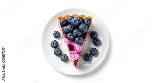 overhead view of a slice of pink cheesecake with blueberries on top