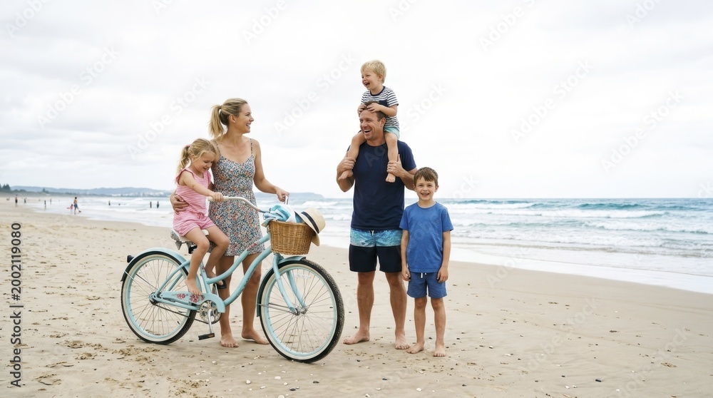 Fototapeta premium Family with children and bicycle having fun on the beach in summer