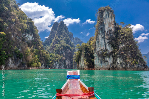 Longtail boat navigating in Cheow Lan Lake, Khao Sok National Park, Ban Ta Khun, Thailand, Southeast Asia.