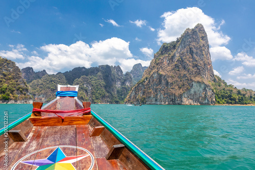 Longtail boat navigating in Cheow Lan Lake, Khao Sok National Park, Ban Ta Khun, Thailand, Southeast Asia.