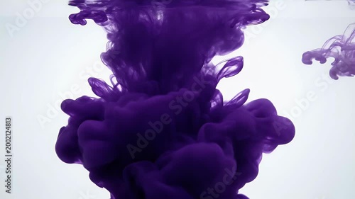 A captivating image showcases dark ink gracefully dispersing and swirling within clear water, creating an abstract and mesmerizing visual effect.