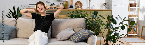 Canvas Print Joyful moments of a young woman relaxing and enjoying her home in a cozy living