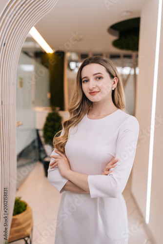 Professional cosmetologist woman standing with arms crossed in modern beauty clinic, representing expertise, care, and business success in health and wellness industry. Concept of beauty treatment. Free Download Professional cosmetologist woman standing with arms crossed in modern beauty clinic, representing expertise, care, and business success in health and wellness industry. Concept of beauty treatment. - GFXLoad