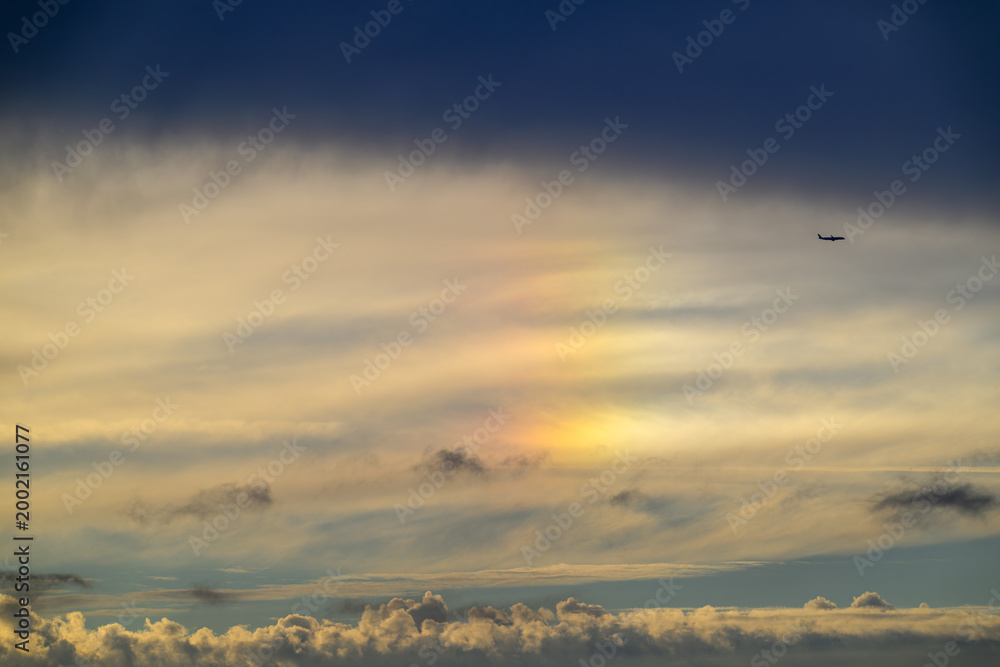Fototapeta premium A beautiful sundog or parhelion phenomenon appearing in the clouds above Tamsui Bridge in New Taipei City, Taiwan, during a summer sunset.