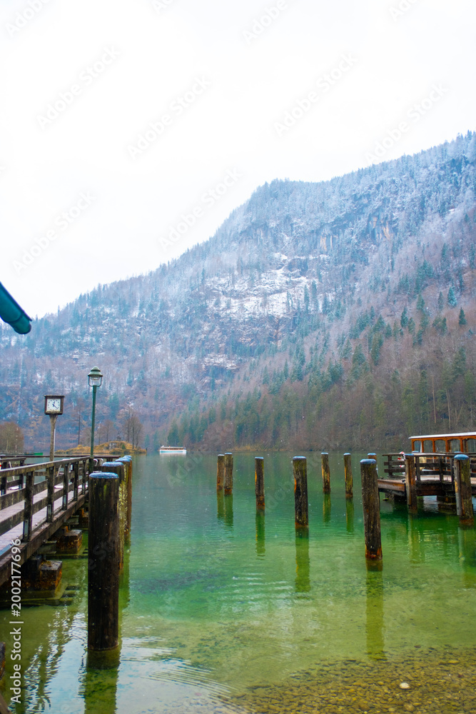 Fototapeta premium Königssee with snowy mountain and wooden pier