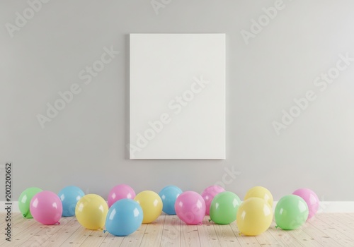 Colorful balloons arranged below a blank frame on a wooden floor