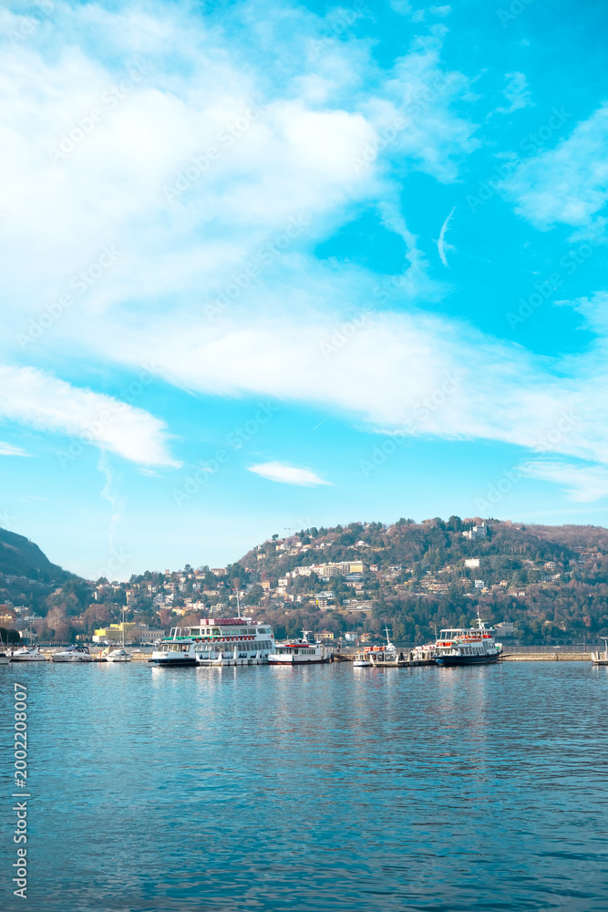 Fototapeta premium Lake Como water and hillside town with boats