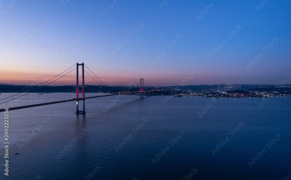 Fototapeta premium Osmangazi Bridge in Kocaeli, Turkey. Aerial shot with drone. Beautiful sunset landscape.