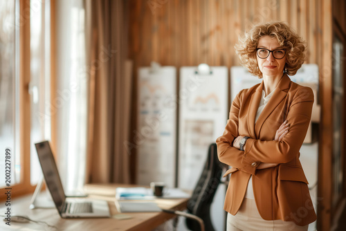 Business professional stands confidently in a modern office space while working on a project during the day