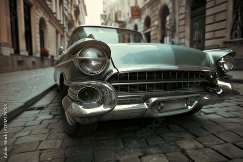 Classic car parked on a cobblestone street in a historic town during the morning