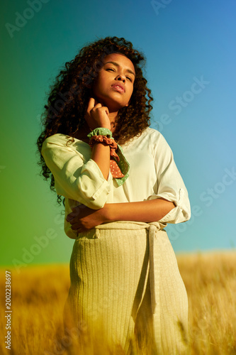 Woman enjoying summer freedom in golden wheat field