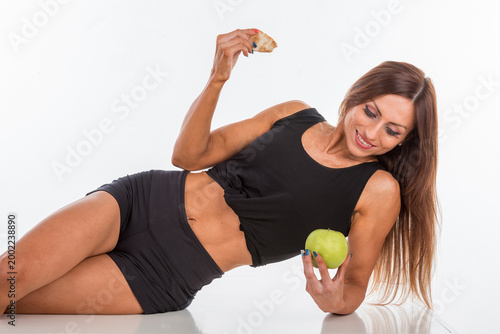 Tableau sur toile Woman smiles while holding apple and crumb