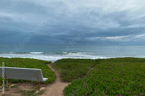 Empty Coastal Bench Under Heavy Storm Clouds, Solitude Concept