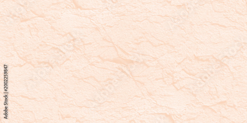 Pale peach textured stone wall background with subtle grain and natural plaster finish for minimalist interior design